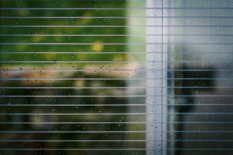 a close up of a window covered in rain